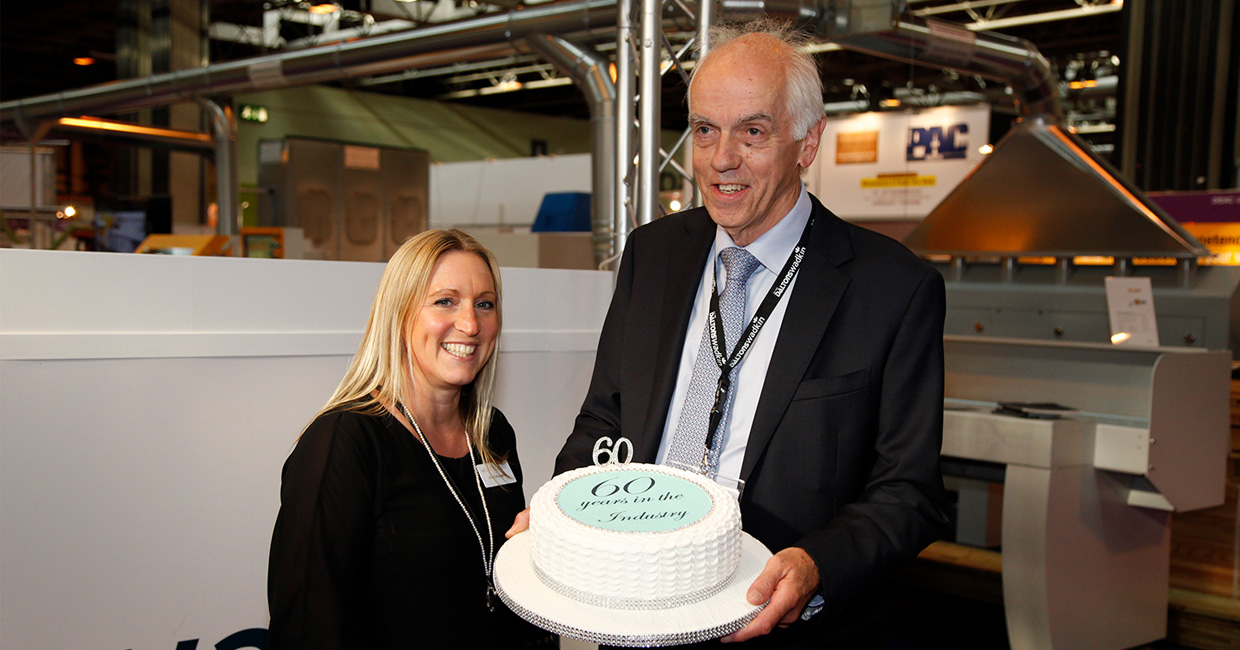Francis Dalton being presented with a celebratory cake by W16 event director Lisa Campagnola