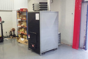 Insulation business buys wood waste heater to save money on heating bills